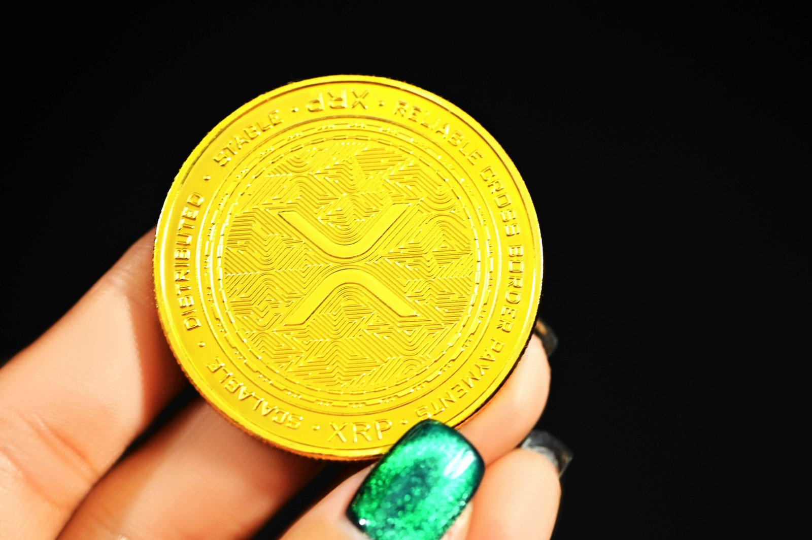 gold round coin on persons hand